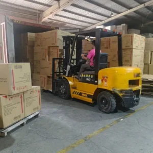 Forklift loading bathroom vanity containers for export, showing 60-80 containers monthly capacity.